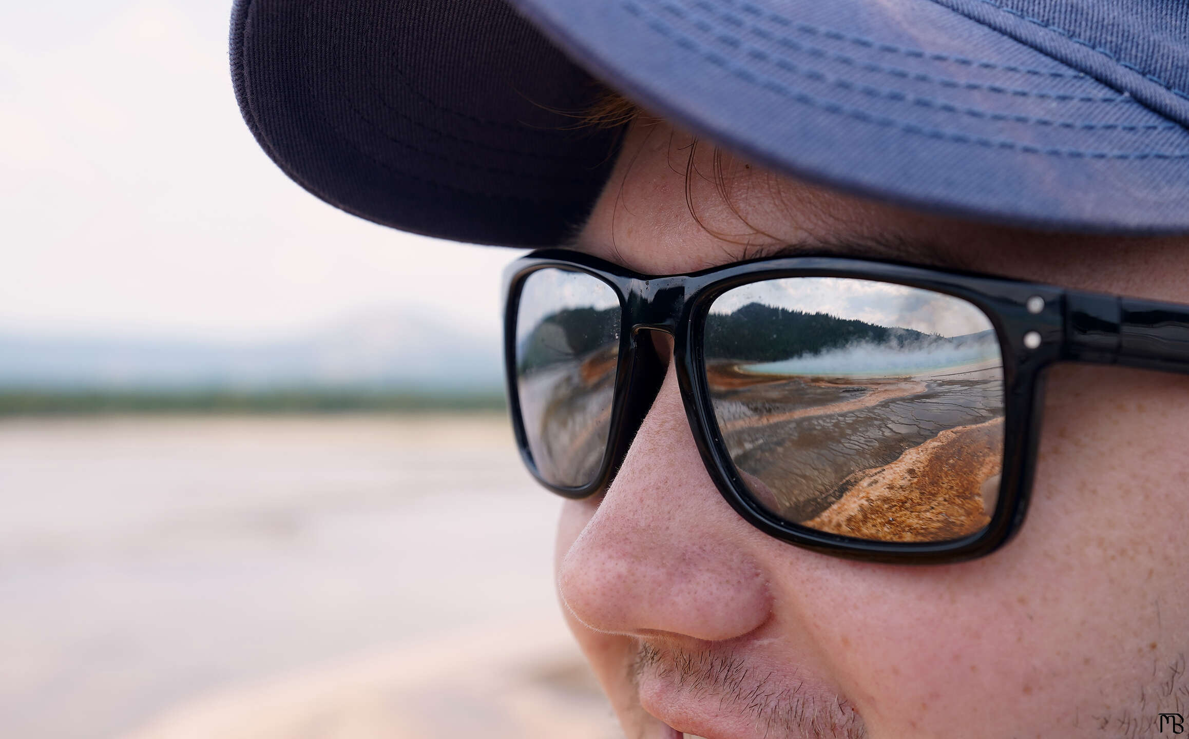 Reflection of the Grand Prismatic Spring in glasses
