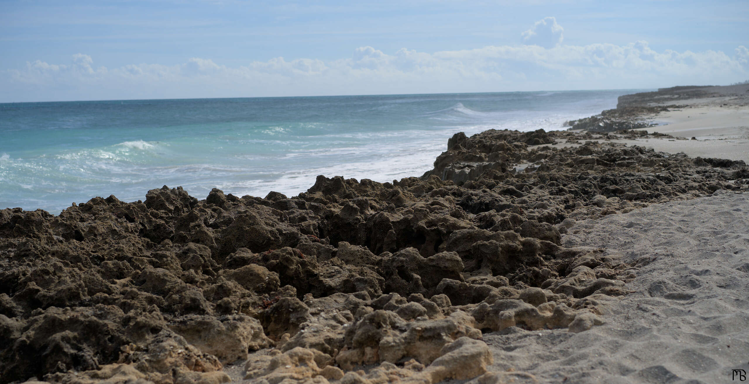 Blue sea by rocky beach