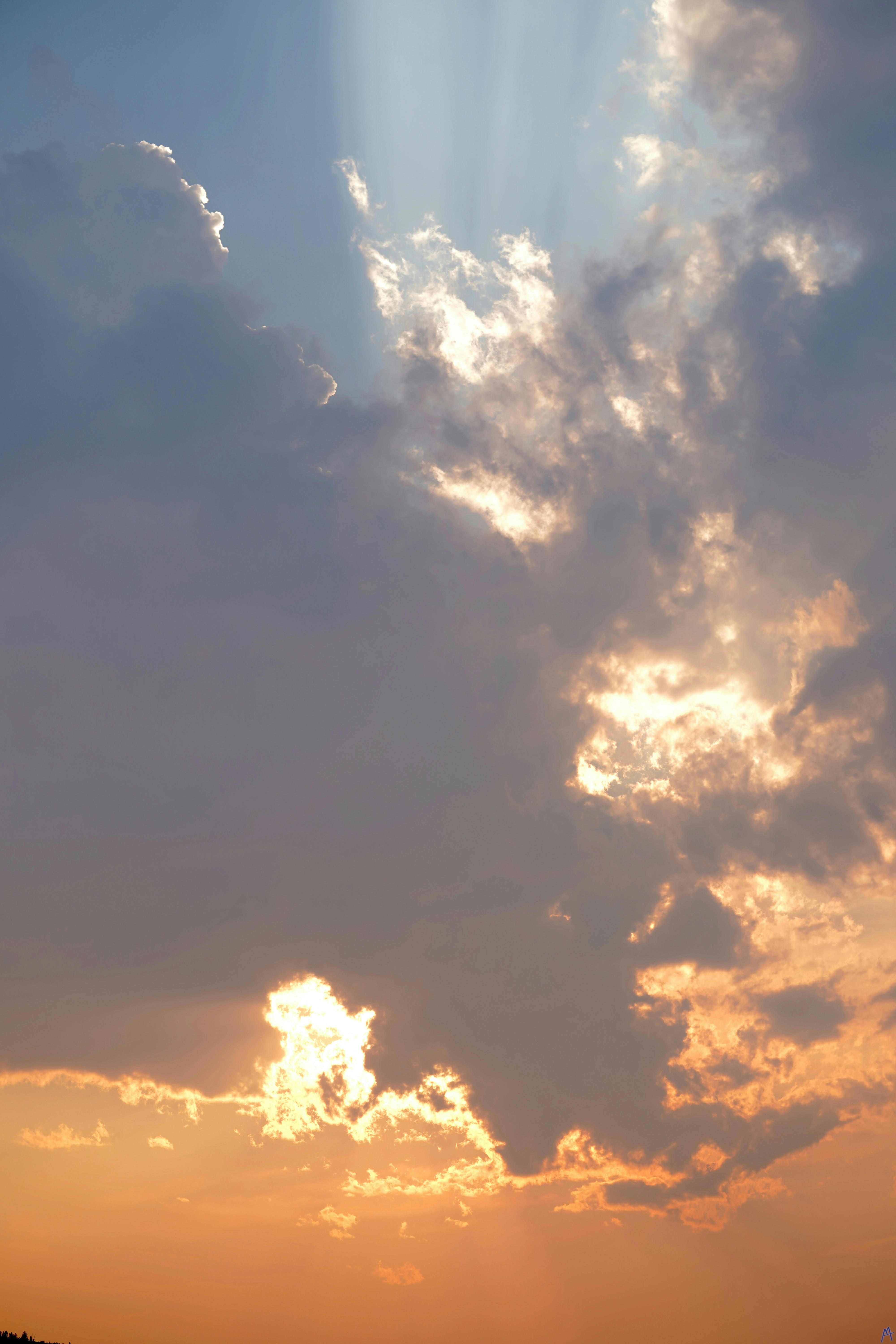 Blue cloud blocking an orange sunset at Yellowstone