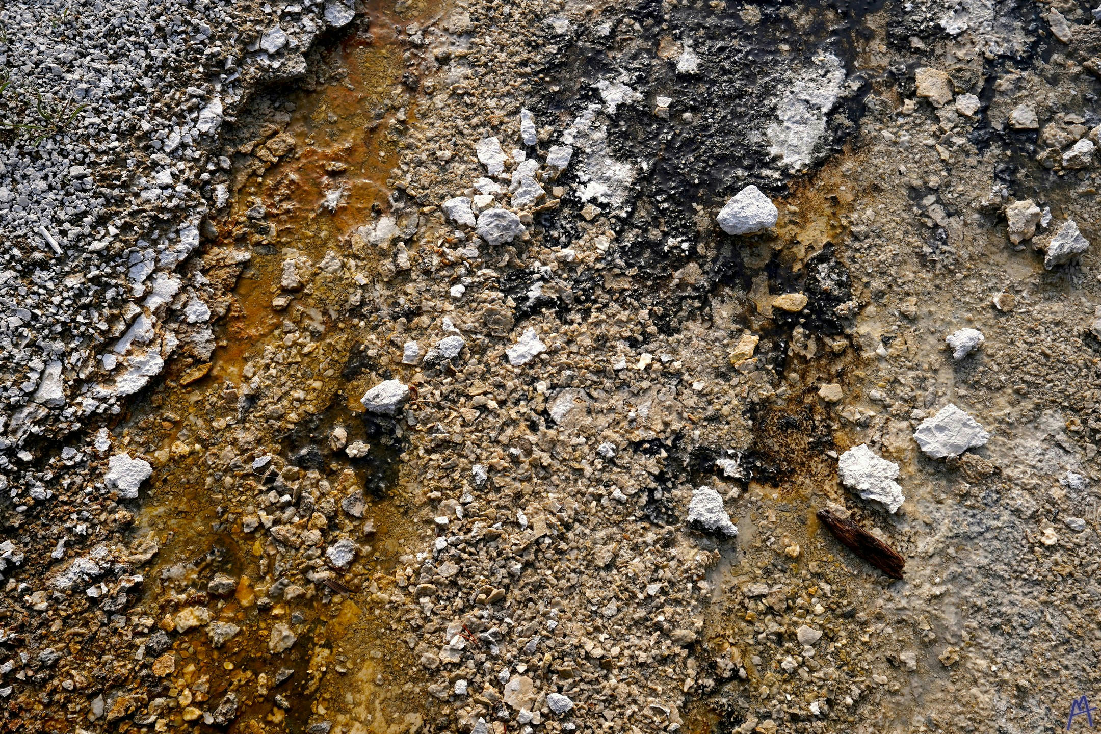 Yellow orange and black hot spring runoff at Yellowstone