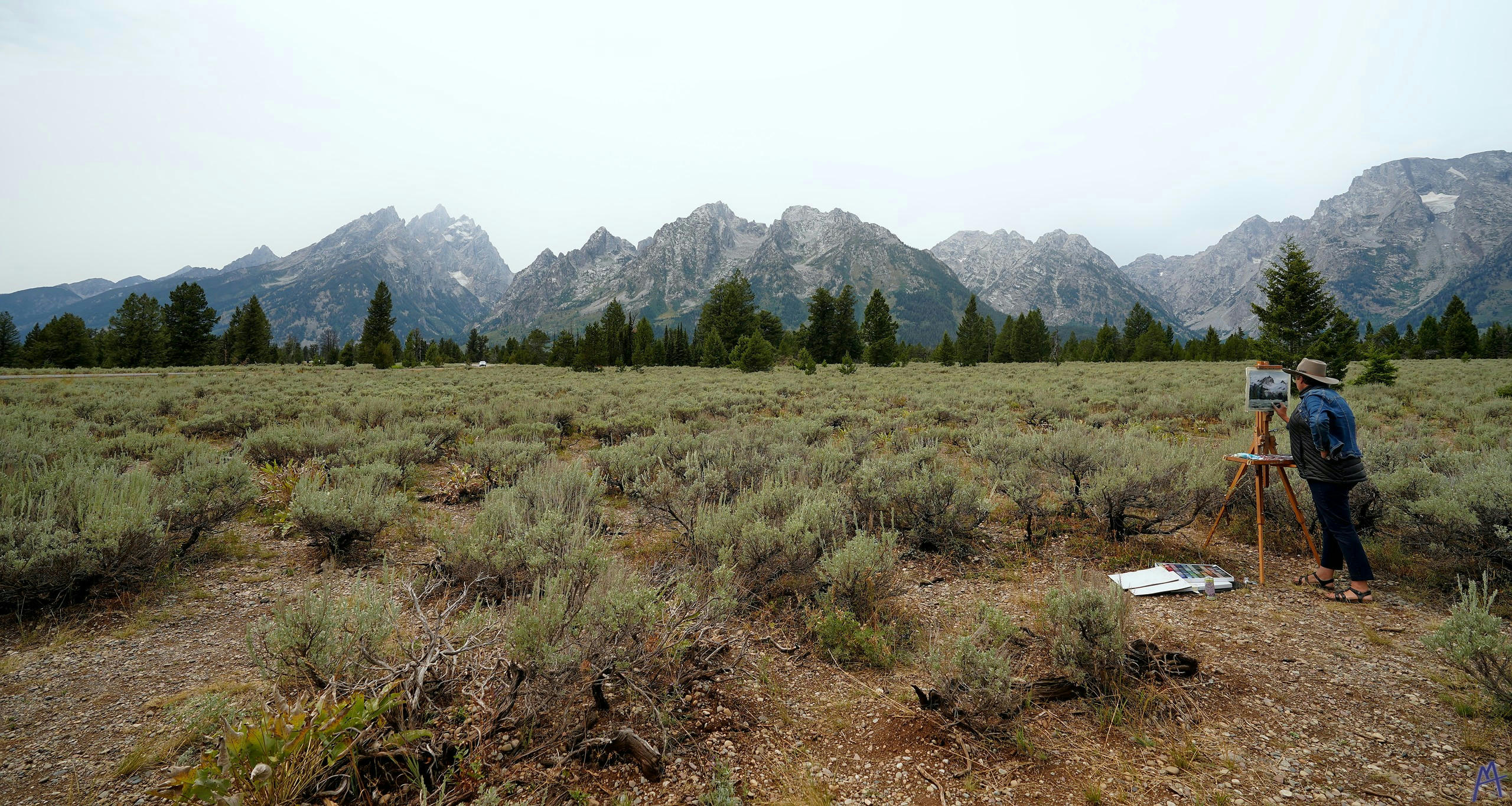 Painter paints the mountain range at Grand Teton