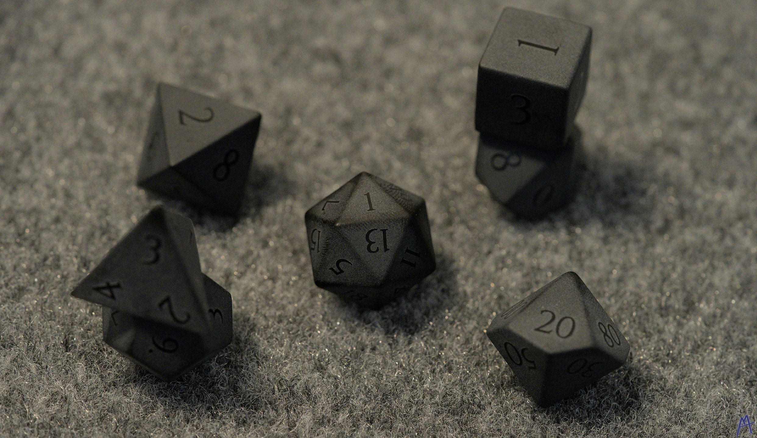 Black obsidian dice on a table