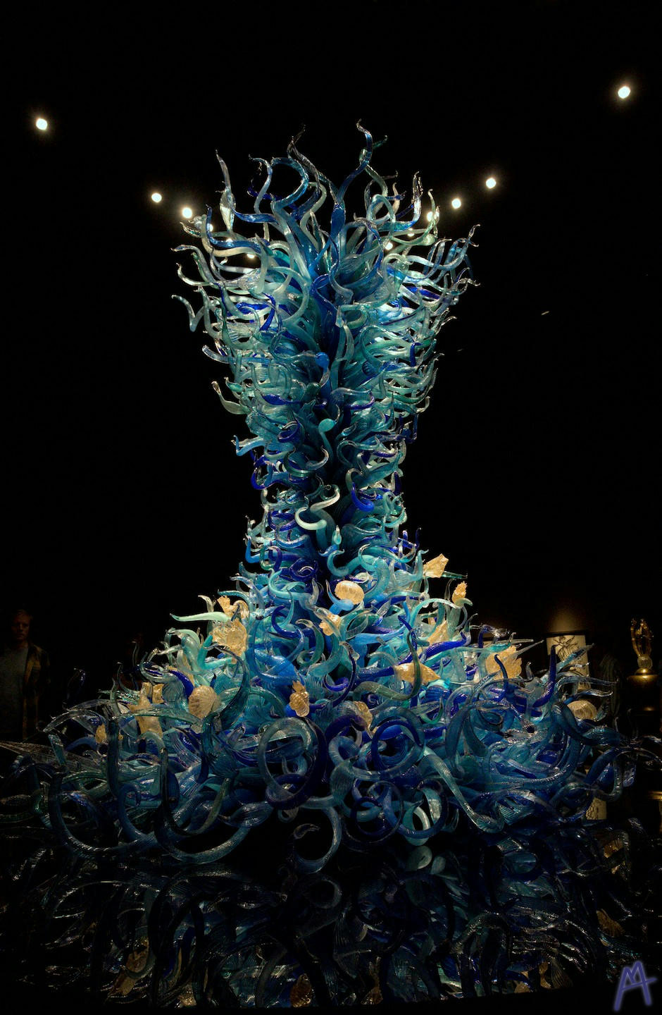 Blue and yellow glass statue in the dark